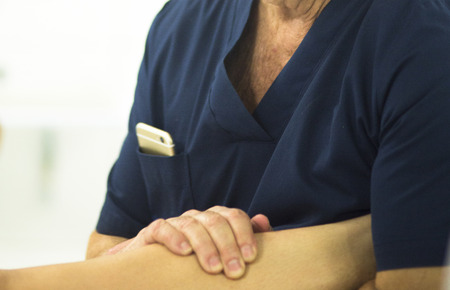 Surgeon in hospital surgery in sterile uniform scrubs in operating theater emergency room in knee...