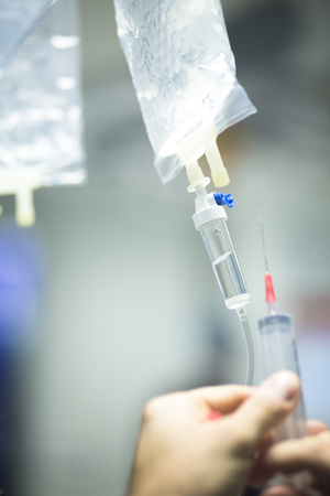 Hospital surgery medical drip in emergency room operating theater ward in medical clinic.の写真素材