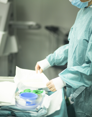 Surgeon in hospital surgery in sterile uniform "scrubs" in operating theater emergency room in surgical operation.の写真素材