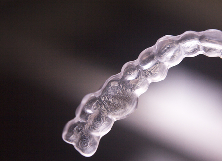 Invisible plastic modern technology dental tooth brackets aligners to correct teeth alignment in aesthetic dentistry.の写真素材