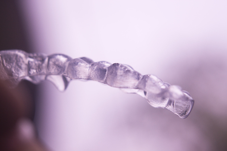 Invisible plastic modern technology dental tooth brackets aligners to correct teeth alignment in aesthetic dentistry.の写真素材