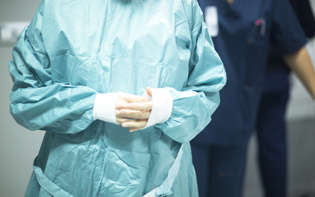 Surgeon in hospital surgery in sterile uniform "scrubs" in operating theater emergency room in surgical operation.の写真素材