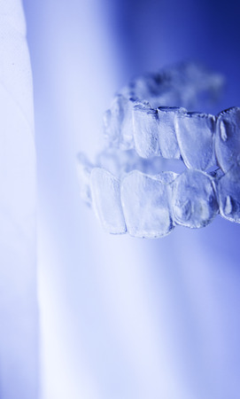 Invisible orthodontics cosmetic brackets tooth aligners plastic braces modern teeth retainers isolated closeup.の写真素材