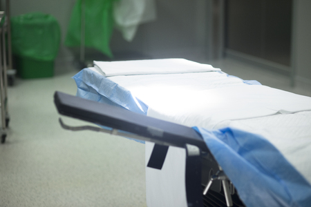 Hospital ward emergency room operating theater, patient bed and modern equipment.