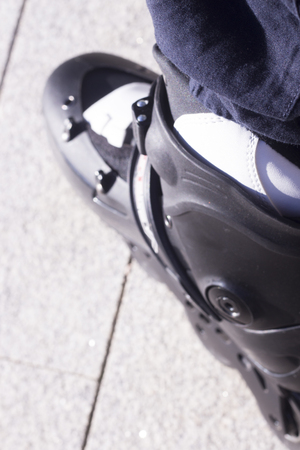 Inline freestyle roller blade skates in street on road surface skating.