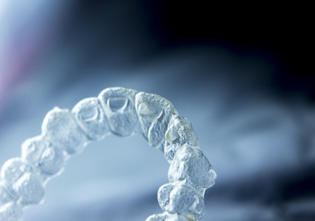 Invisible orthodontics cosmetic brackets tooth aligners plastic braces modern teeth retainers isolated closeup.の写真素材