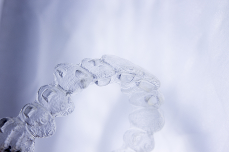 Invisible orthodontics cosmetic brackets tooth aligners plastic braces modern teeth retainers isolated closeup.の写真素材