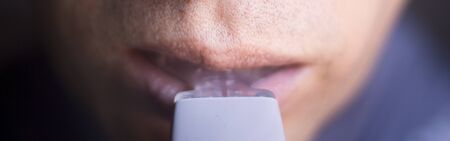 Man using ental braces aligners accelerator for both modern invisible and metal brackets to...