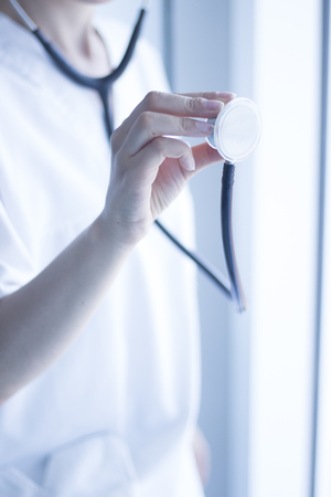 Doctors medical stethoscope heart rate monitoring equipment to listen to heartbeats of patient,の写真素材