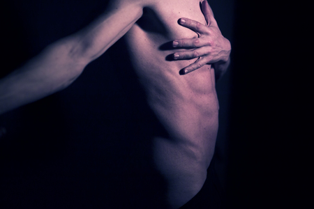 Sexy male nude slim athletic man with naked torso, chest and abs. Toned athletic physique with natural non steroid look.の写真素材