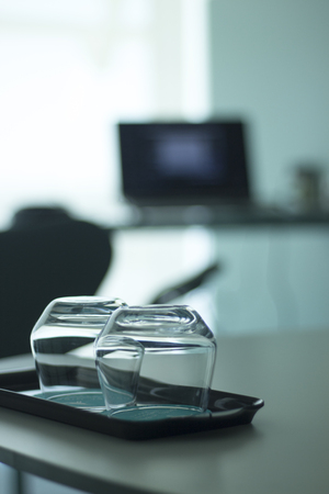 Luxury five star hotel bedroom water or whisky drinking glasses on table on tray.の写真素材