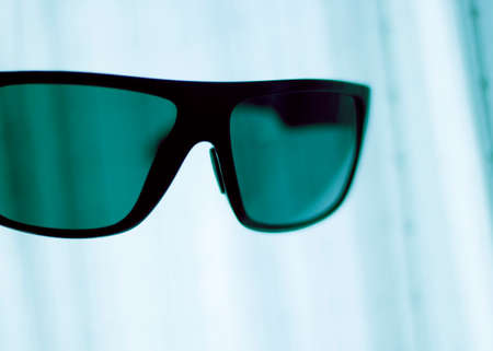 Men's fashion sunglasses. Dark tinted UV protection glasses used to protect the eyes from the sun.の写真素材