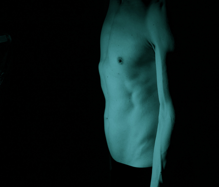 Sexy male nude slim athletic man with naked torso, chest and abs. Toned athletic physique with natural non steroid look.の写真素材