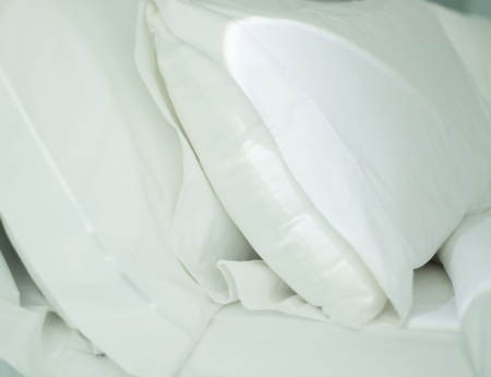 Luxury five star hotel bedroom bed sheets and linen clean and pressed with room ready and cleaned.の写真素材