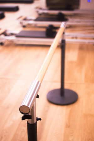 Pilates exercise training and flexibility stretching bar equipment in gym yoga and wellbeing studio.