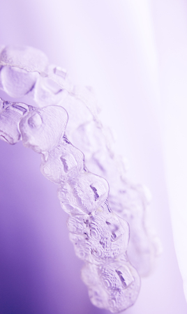 Invisible orthodontics cosmetic brackets tooth aligners plastic braces modern teeth retainers isolated closeup.の写真素材