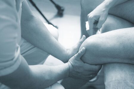 Physical therapy manual physiotherapy treatment by physiotherapist on patient for knee inury rehabilitation.の写真素材