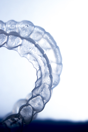 Invisible dental bracket aligners for modern orthodontic treatment to straighten teeth and improve dental hygiene.の写真素材