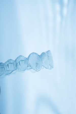 Invisible orthodontics cosmetic brackets tooth aligners plastic braces modern teeth retainers isolated closeup.の写真素材