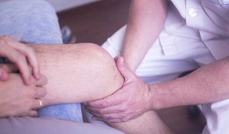 Physical therapy manual physiotherapy treatment by physiotherapist on patient for knee inury...