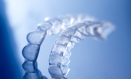 Invisible dental bracket aligners for modern orthodontic treatment to straighten teeth and improve...