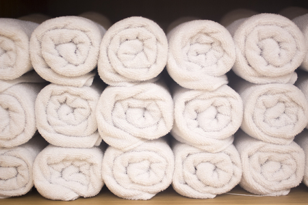 Clean pressed towels in luxury hotel health club spa resort for guests to dry with.の写真素材