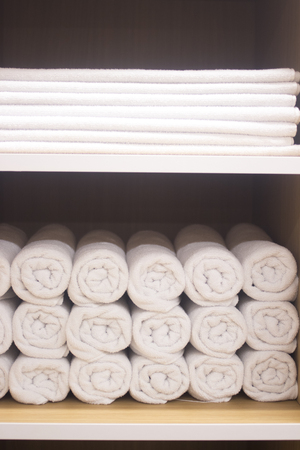 Clean pressed towels in luxury hotel health club spa resort for guests to dry with.の写真素材