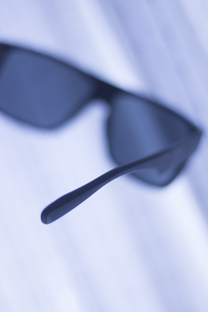 Men's fashion sunglasses. Dark tinted UV protection glasses used to protect the eyes from the sun.