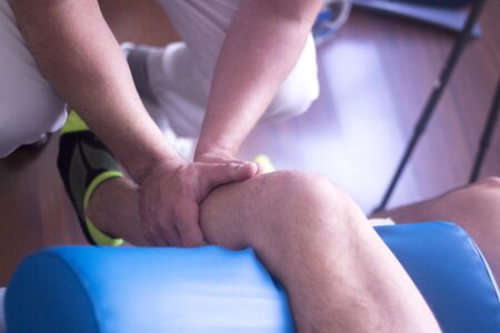 Physical therapy manual physiotherapy treatment by physiotherapist on patient for knee inury rehabilitation.の写真素材