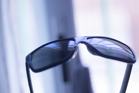 Men's fashion sunglasses. Dark tinted UV protection glasses used to protect the eyes from the sun.