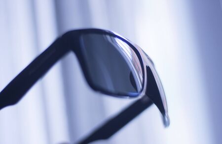 Men's fashion sunglasses. Dark tinted UV protection glasses used to protect the eyes from the sun.の写真素材