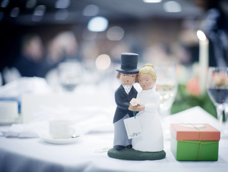 VIP wedding party evening marriage drinks reception with cake topper bride and groom statuettes.の写真素材