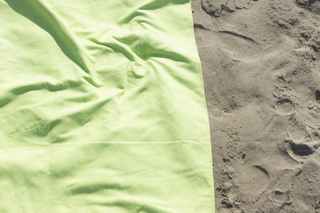 Towel on sandy  beach by the ocean on hot summer day.の写真素材