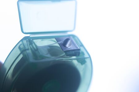 Dental floss tape closeup on plain background.の写真素材