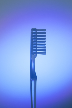 Dental toothbrush closeup isolated on abstract background