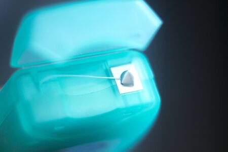 Dental floss tape closeup on plain background.の写真素材