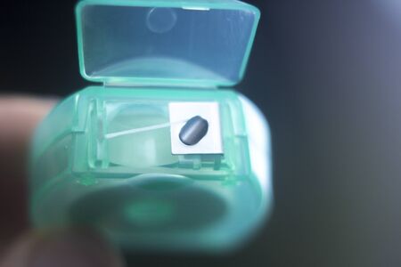 Dental floss tape closeup on plain background.の写真素材