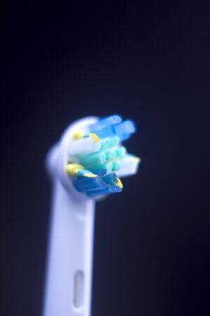 Electric modern tooth brush closeup on plain abstract background.の写真素材