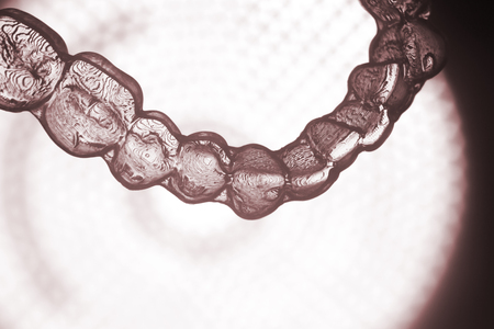 Invisible teeth retainers orthodontic brackets. Plastic modern straighterners to correct tooth alignment.の写真素材