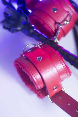 Bondage sadomasochism sex games erotic handcuffs and leather bdsm dominance whip.