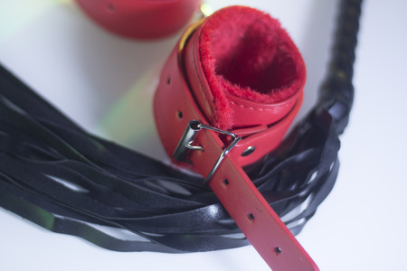 Bondage sadomasochism sex games erotic handcuffs and leather bdsm dominance whip.の写真素材