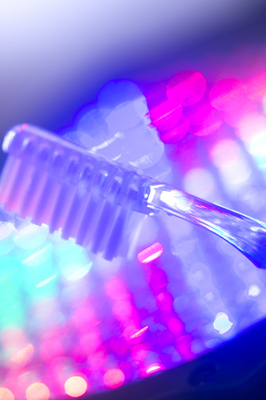 Dental toothbrush closeup isolated on abstract backgroundの写真素材