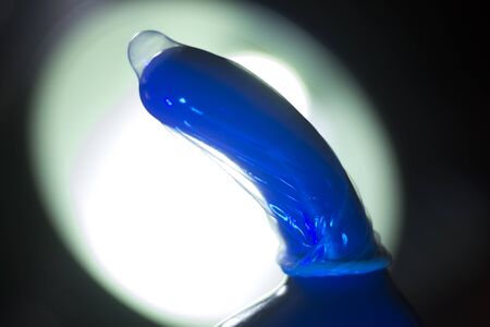 Rubber latex condom male contraceptive on dildo vibrator penis sex toy.の写真素材