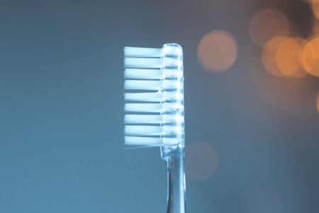 Dental toothbrush closeup isolated on abstract background