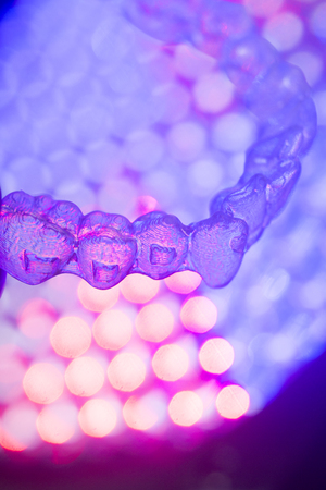 Invisible teeth retainers orthodontic brackets. Plastic modern straighterners to correct tooth alignment.の写真素材