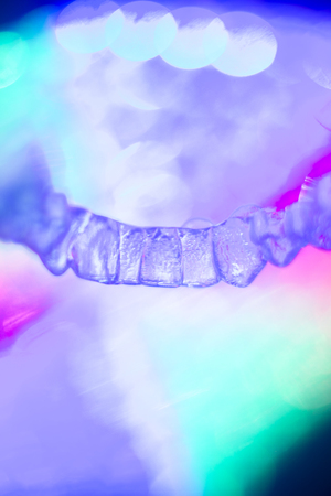 Invisible teeth retainers orthodontic brackets. Plastic modern straighterners to correct tooth alignment.の写真素材