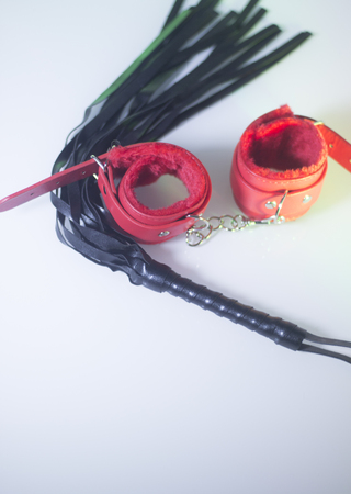 Bondage sadomasochism sex games erotic handcuffs and leather bdsm dominance whip.の写真素材