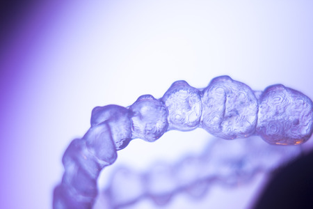Invisible teeth retainers orthodontic brackets. Plastic modern straighterners to correct tooth alignment.の写真素材