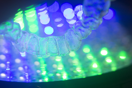Invisible teeth retainers orthodontic brackets. Plastic modern straighterners to correct tooth alignment.の写真素材