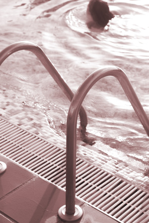 Blue swimming pool on hot sunny day on summer vacation.の写真素材